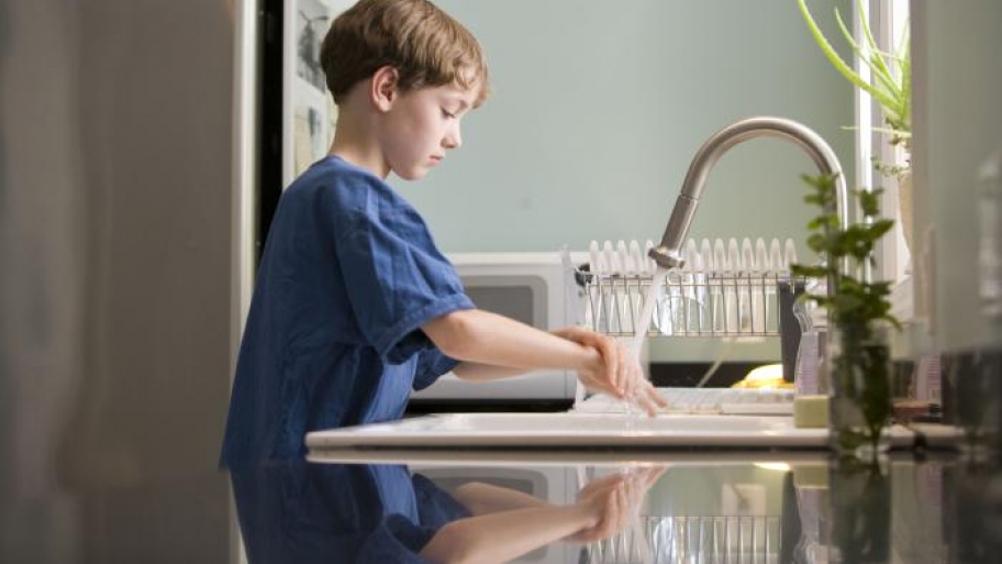 little boy washing his hands